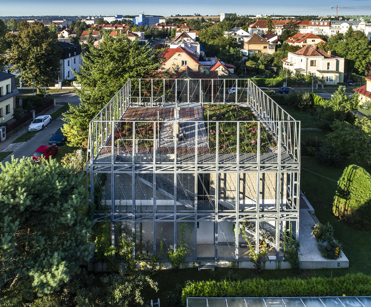 ŠÉPKA Architects wraps old residence with steel lattice featuring climbing plants as facade element