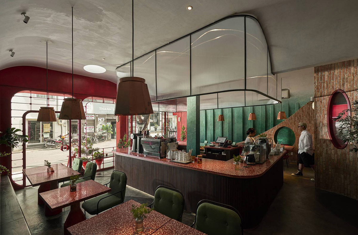 Red5studio built cafe evoking a retro spirit with hues of red colors and lights in Vietnam