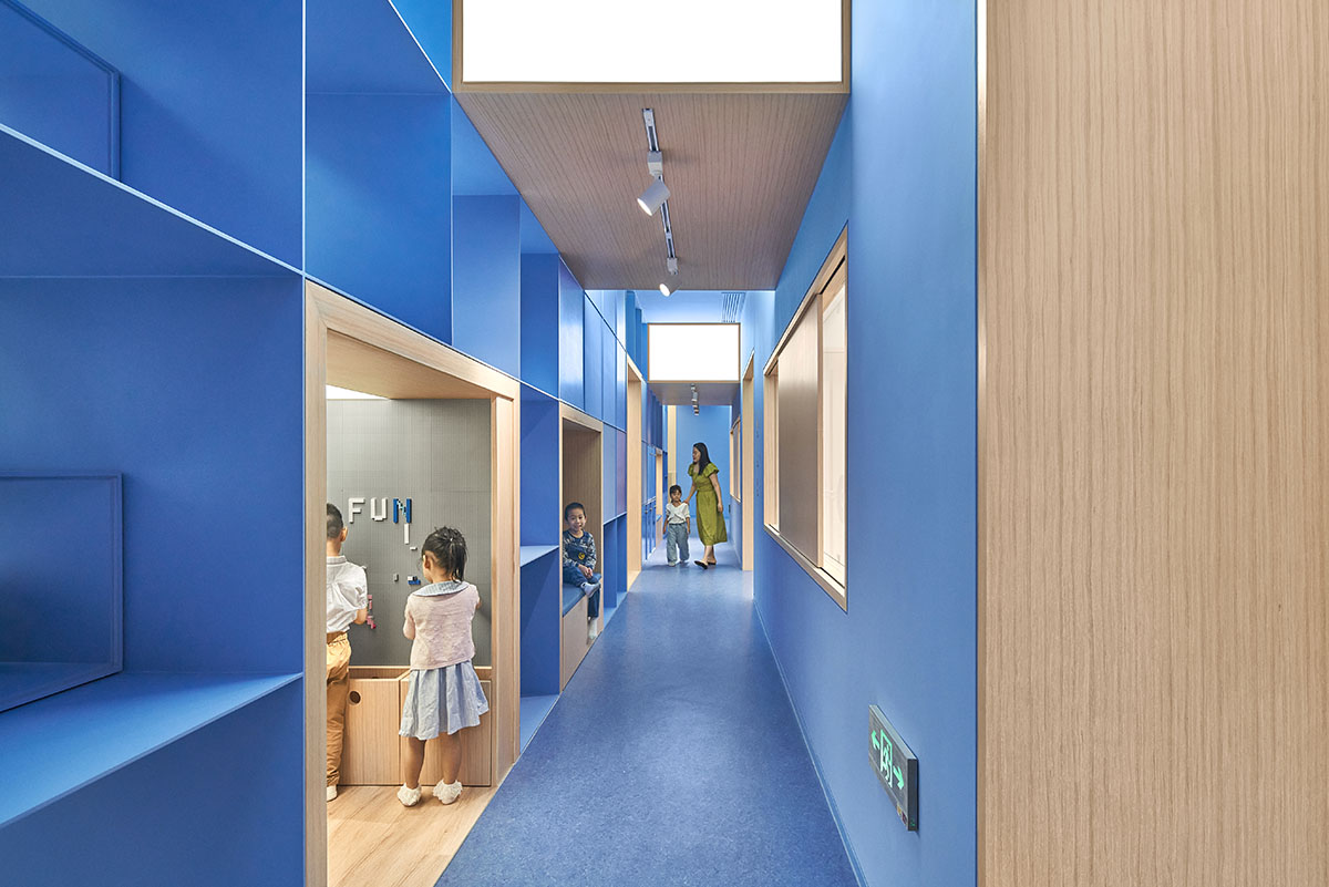 Crossboundaries designs blue sculptural spine as lively interface for Qkids English Center in China