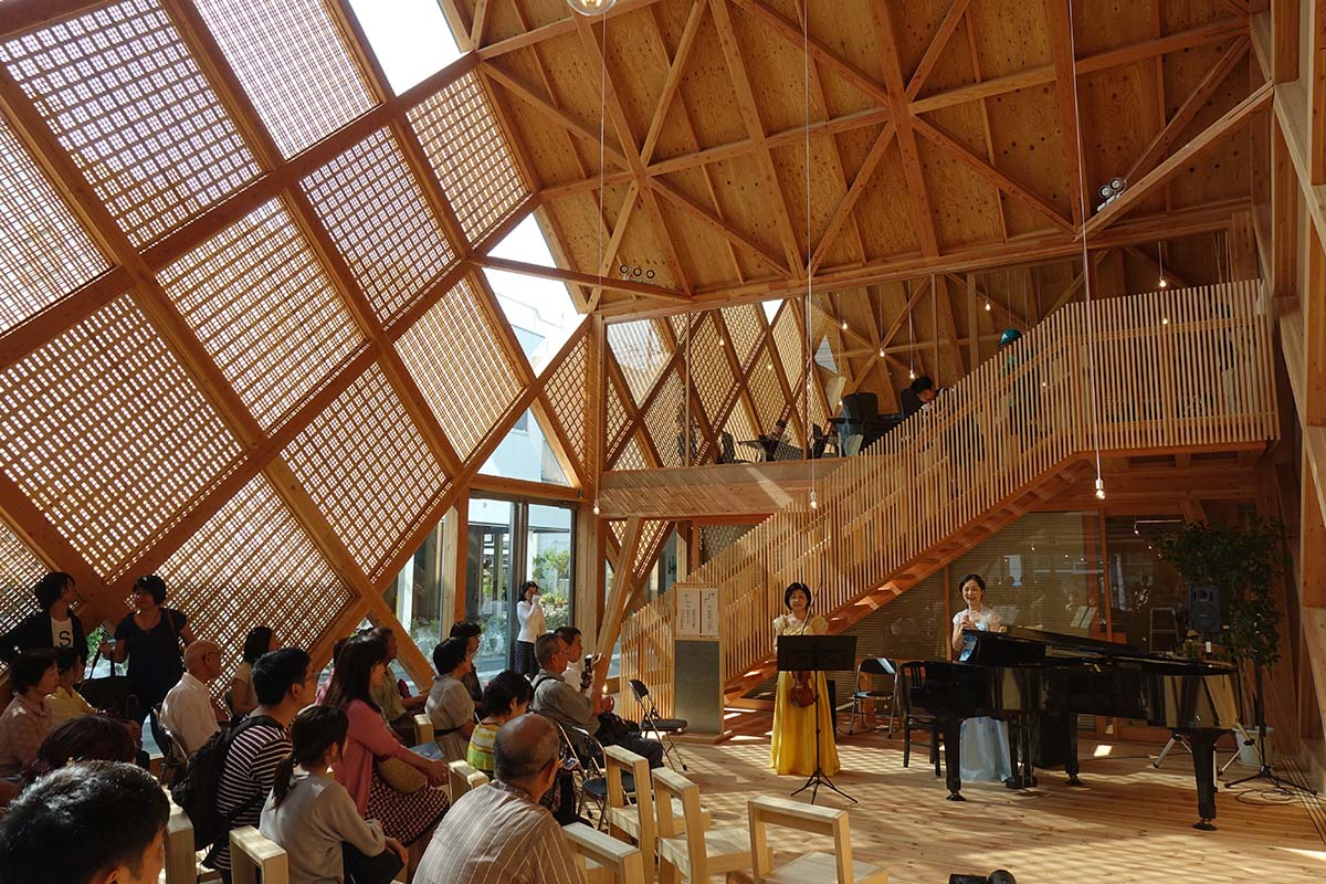 Tezuka Architects' zig zag office building creates lace-like façade with wooden diagonal grids