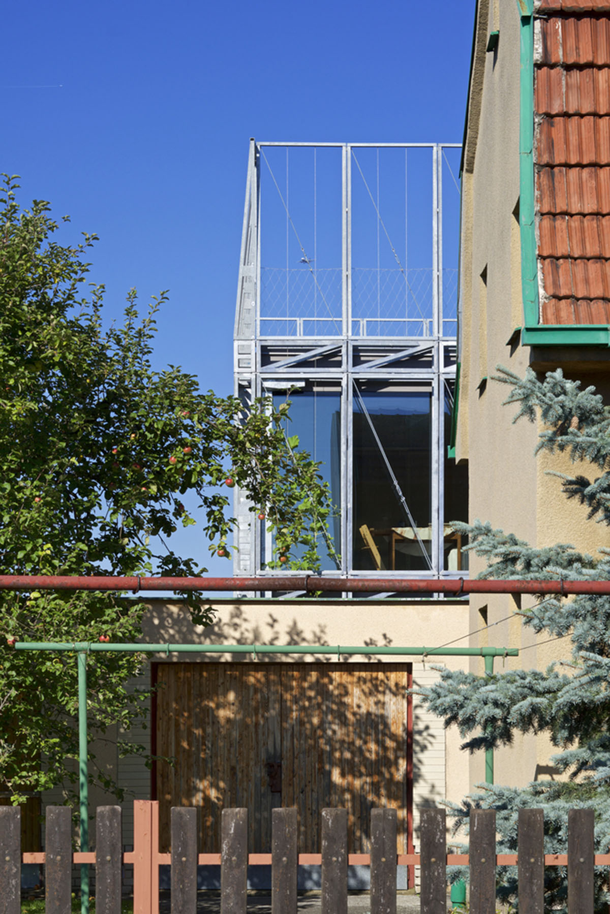 ŠÉPKA Architects wraps old residence with steel lattice featuring climbing plants as facade element