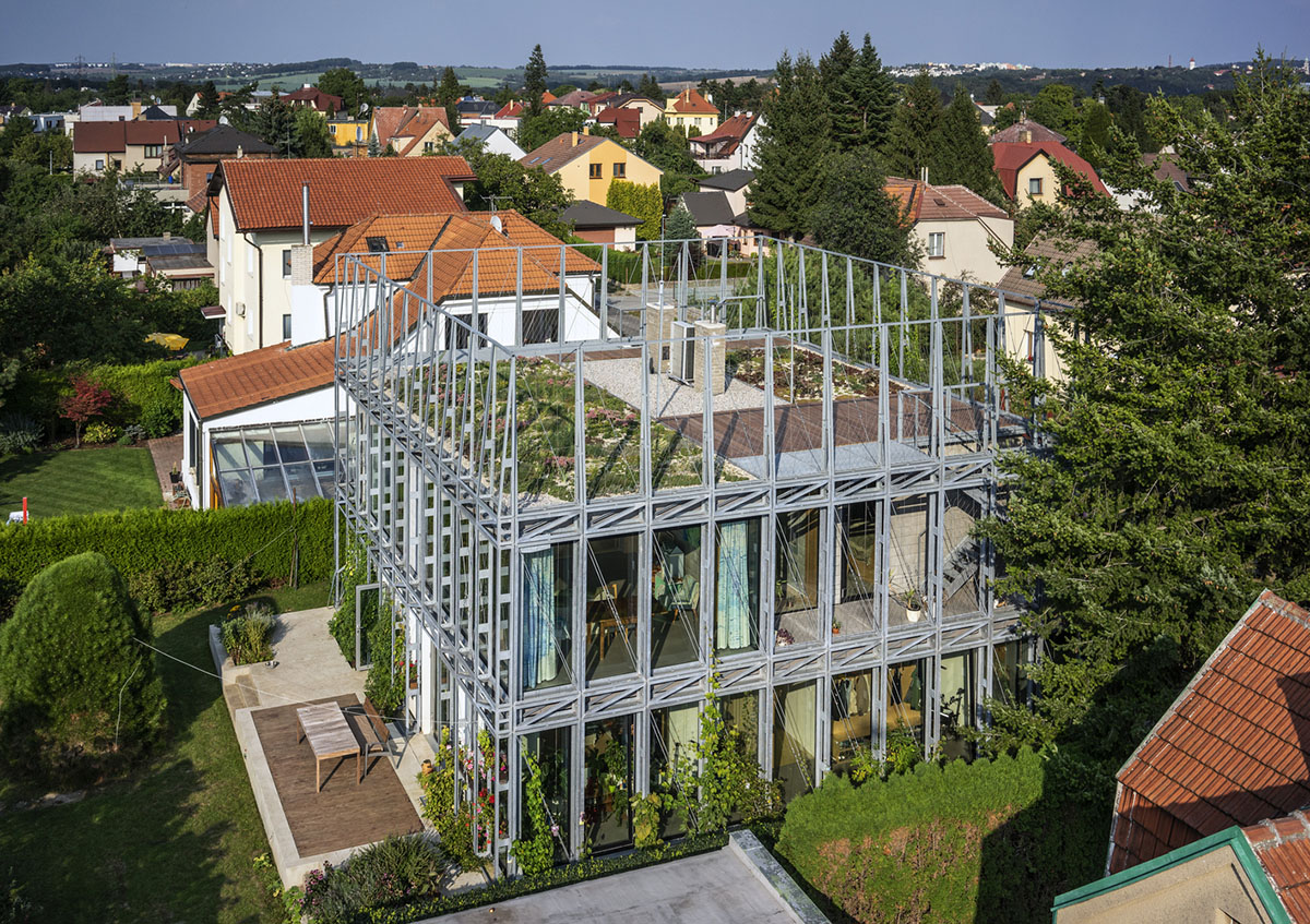 ŠÉPKA Architects wraps old residence with steel lattice featuring climbing plants as facade element