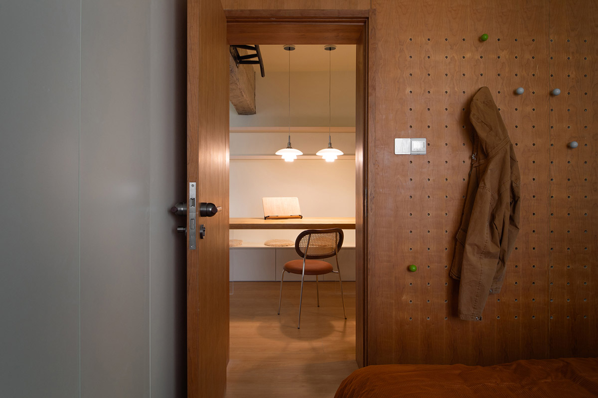 Cherry wood bookcase shapes this house by Atelier D+Y to create flexible interior in Shanghai