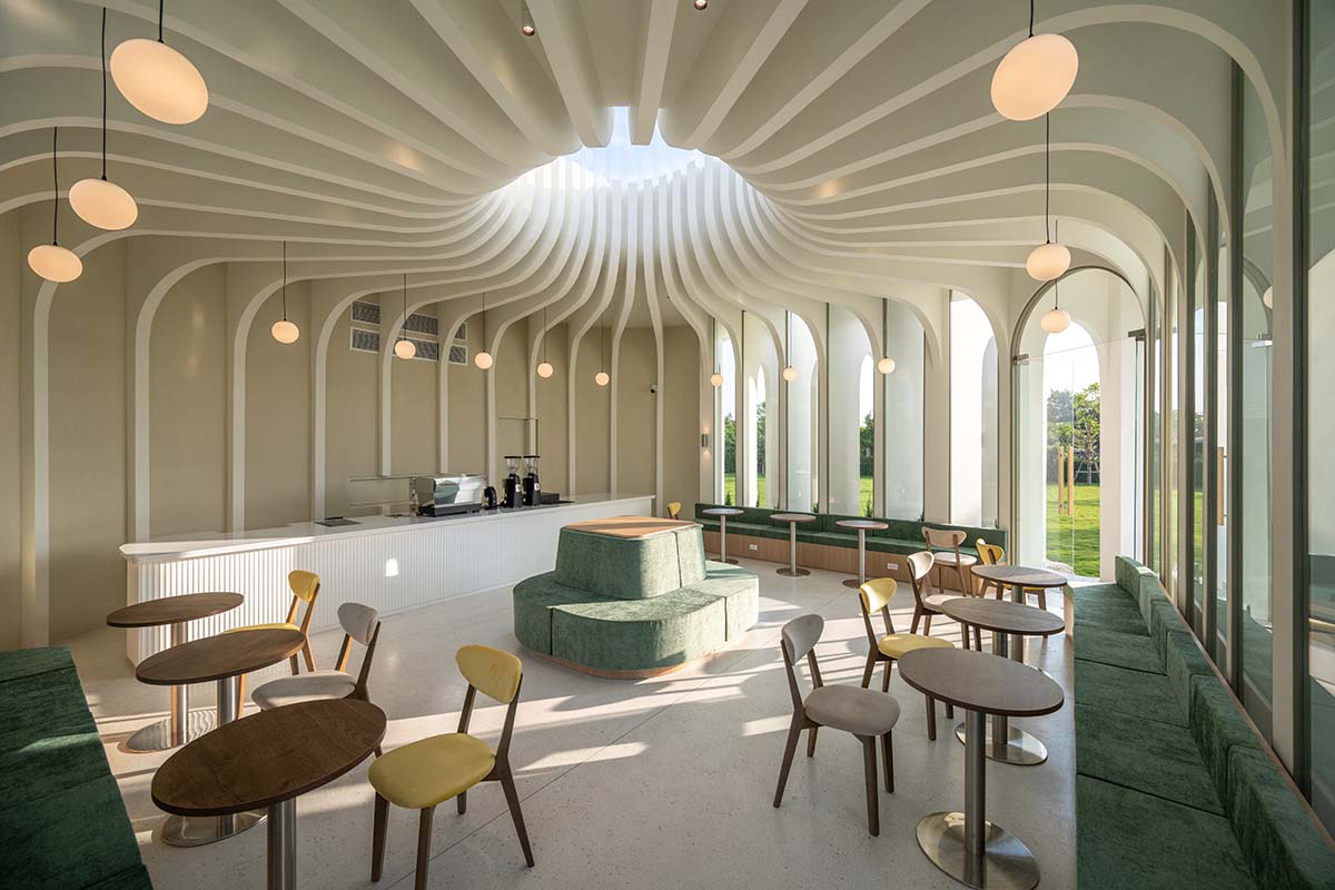 A flower-inspired cafe blooms in a fluid design within Bangkok's industrial landscape