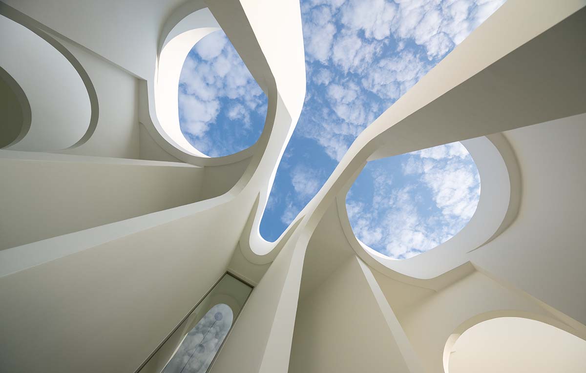 A flower-inspired cafe blooms in a fluid design within Bangkok's industrial landscape