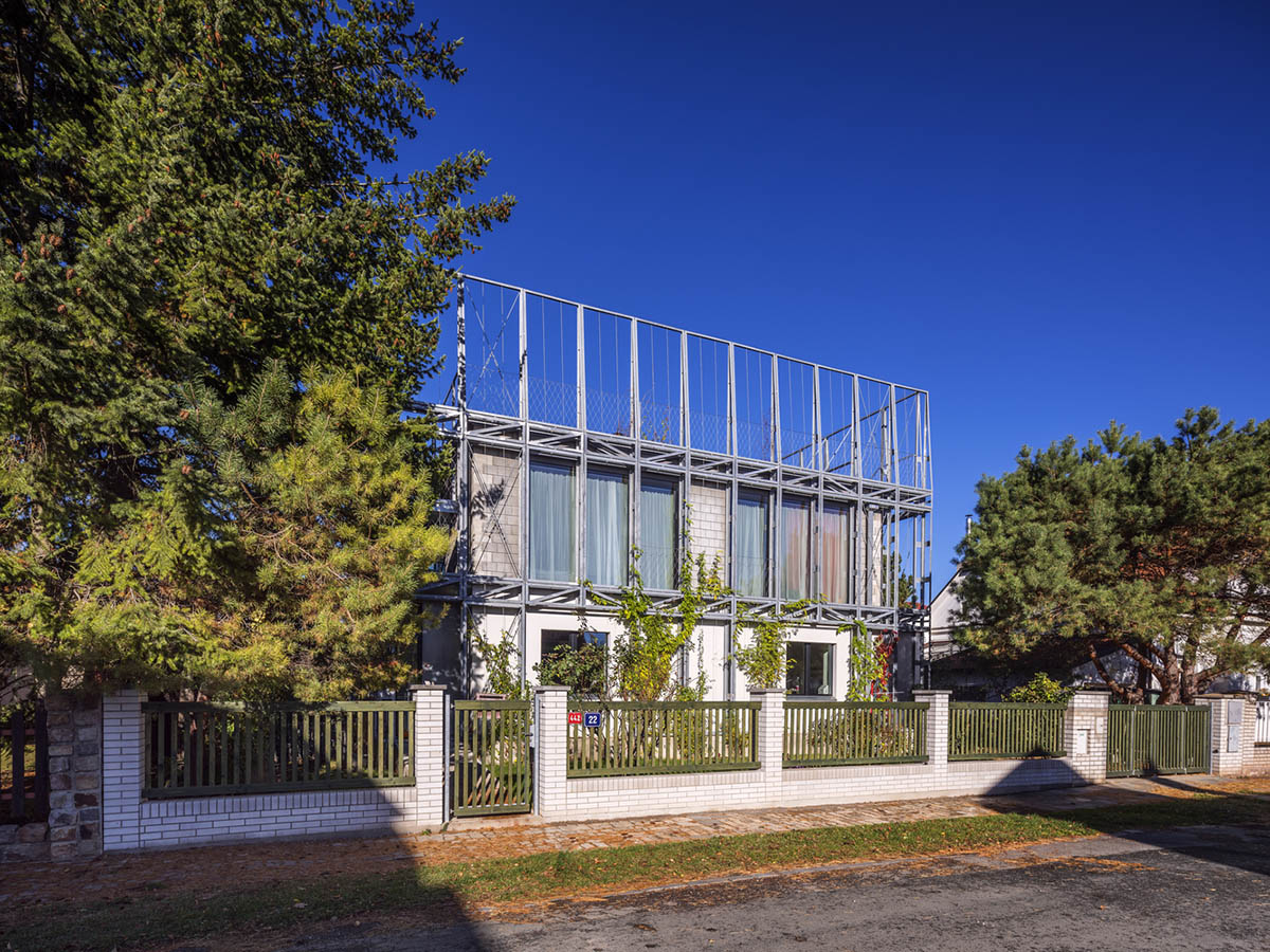ŠÉPKA Architects wraps old residence with steel lattice featuring climbing plants as facade element