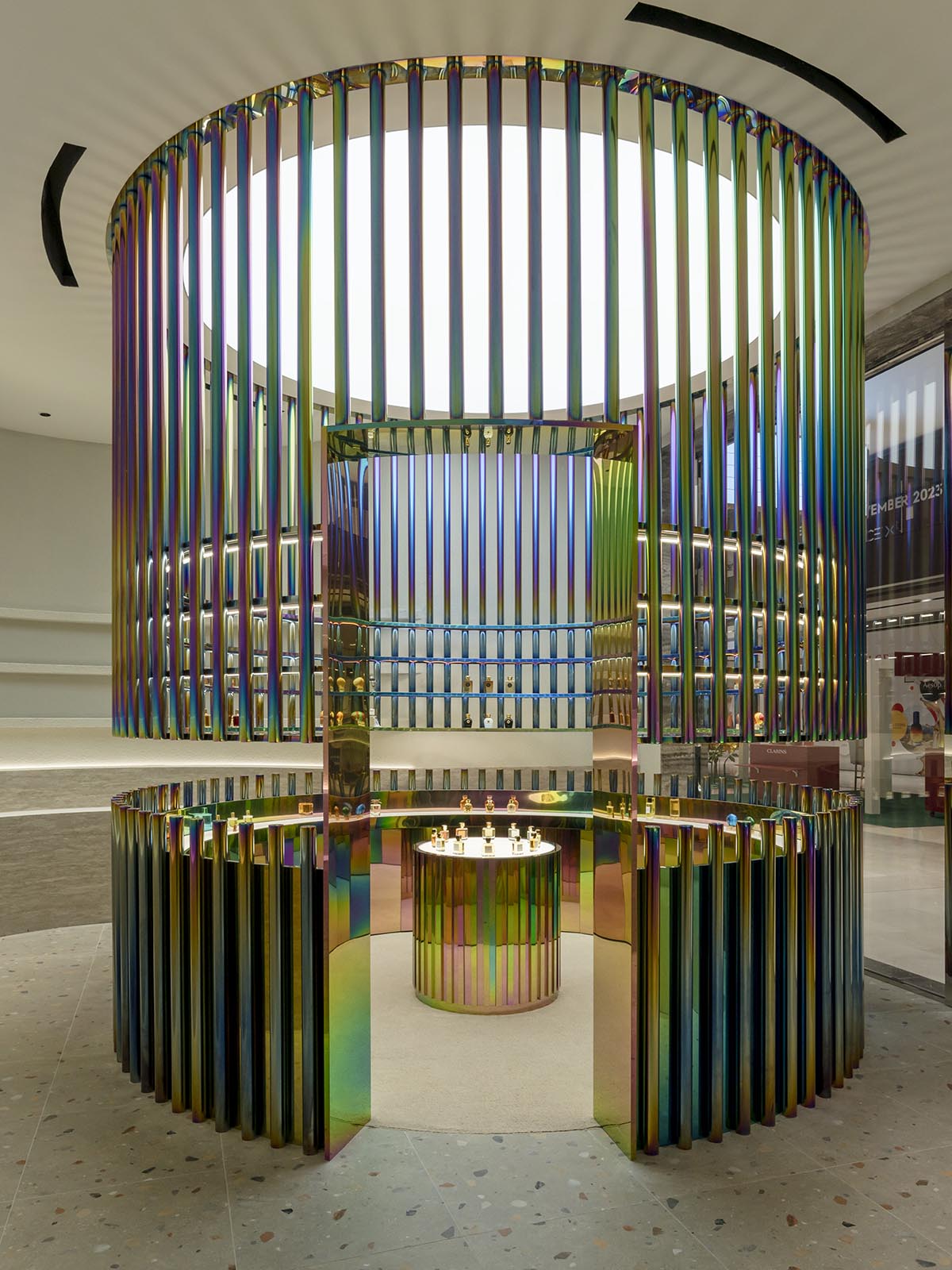 Spacemen adds circular stainless-steel rainbow cabin to a beauty store in Kuala Lumpur
