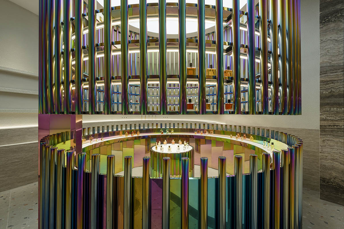 Spacemen adds circular stainless-steel rainbow cabin to a beauty store in Kuala Lumpur