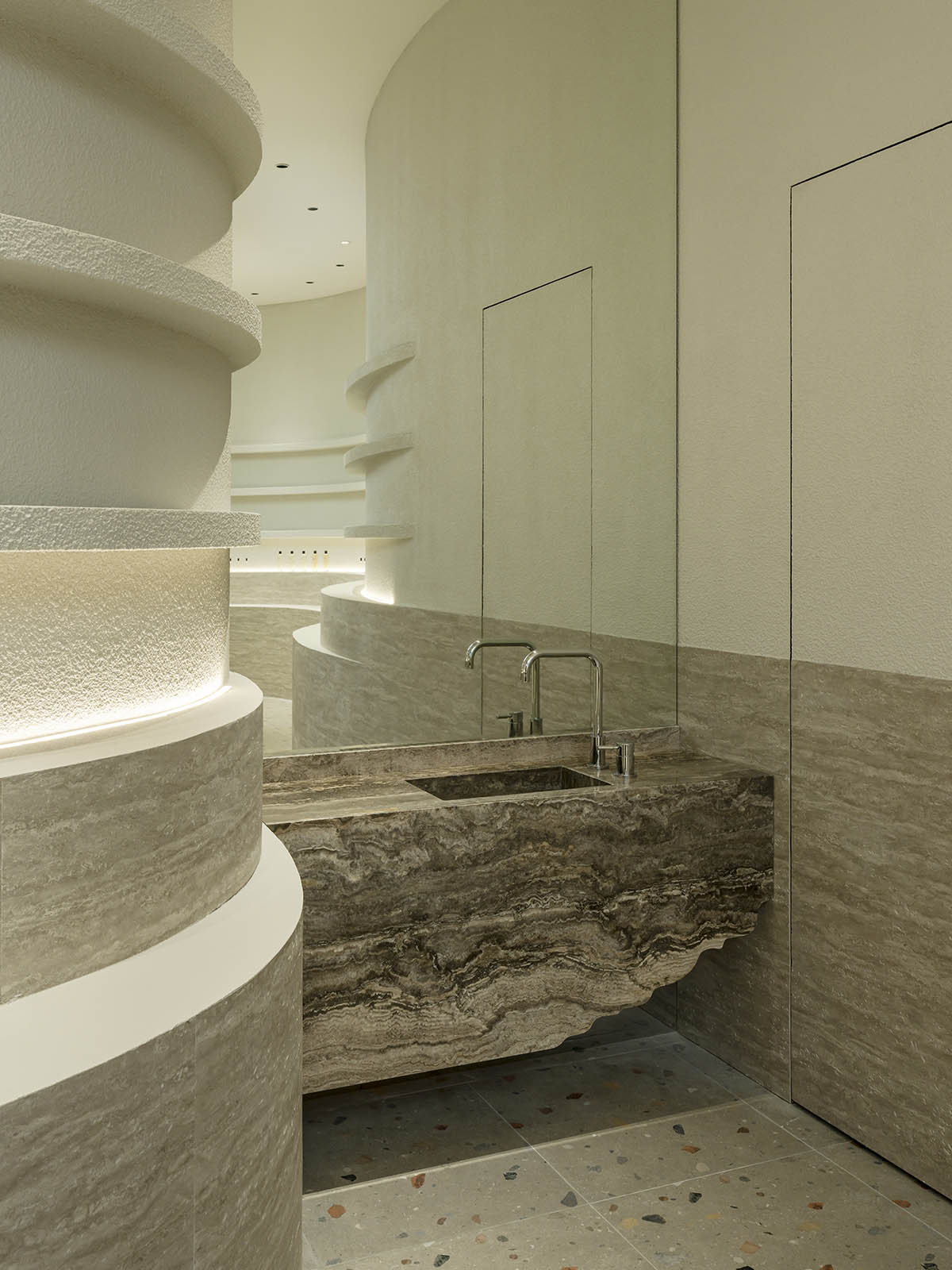 Spacemen adds circular stainless-steel rainbow cabin to a beauty store in Kuala Lumpur