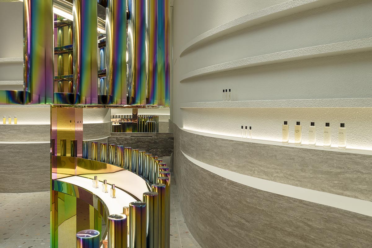 Spacemen adds circular stainless-steel rainbow cabin to a beauty store in Kuala Lumpur