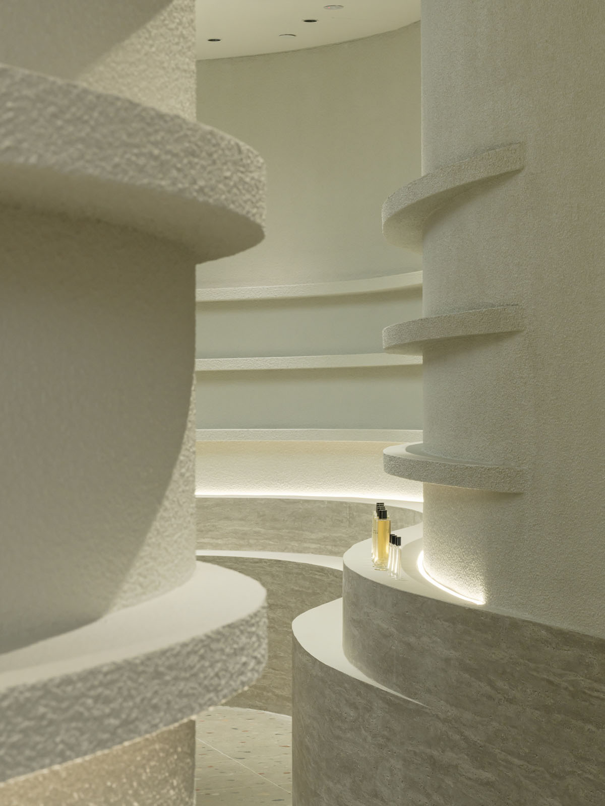 Spacemen adds circular stainless-steel rainbow cabin to a beauty store in Kuala Lumpur