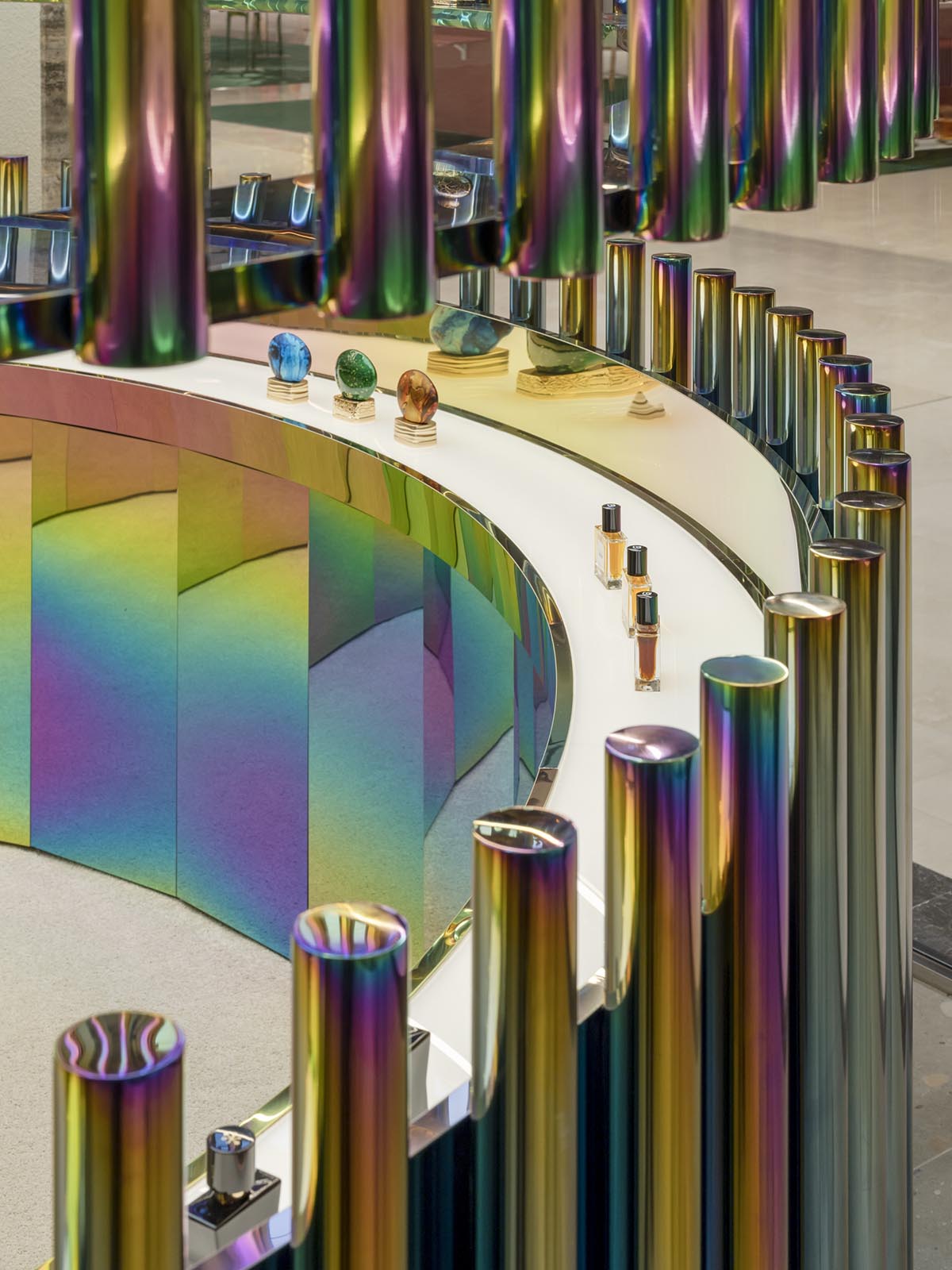 Spacemen adds circular stainless-steel rainbow cabin to a beauty store in Kuala Lumpur