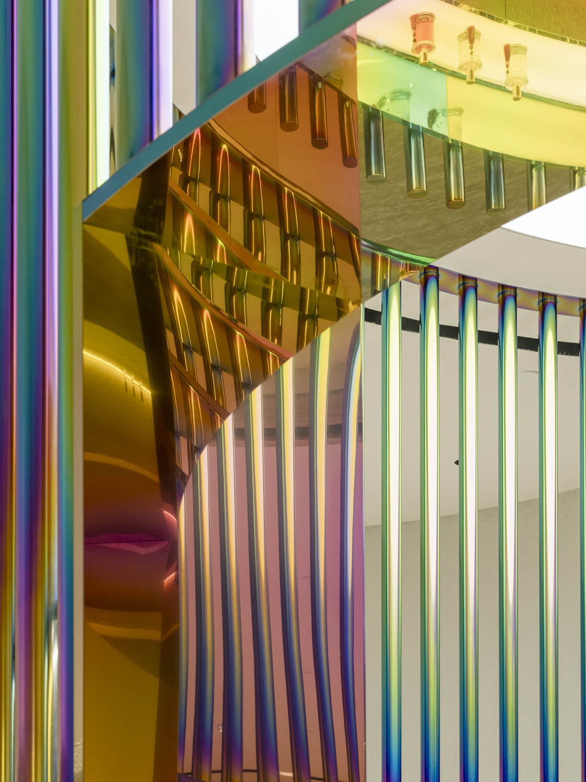 Spacemen adds circular stainless-steel rainbow cabin to a beauty store in Kuala Lumpur