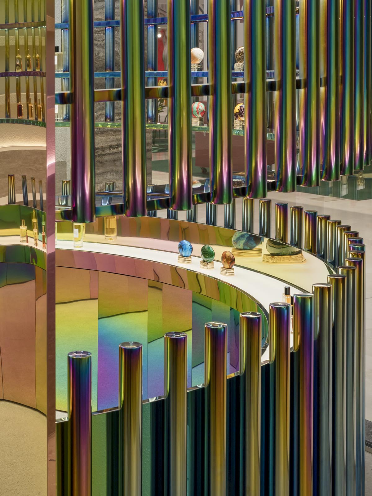 Spacemen adds circular stainless-steel rainbow cabin to a beauty store in Kuala Lumpur