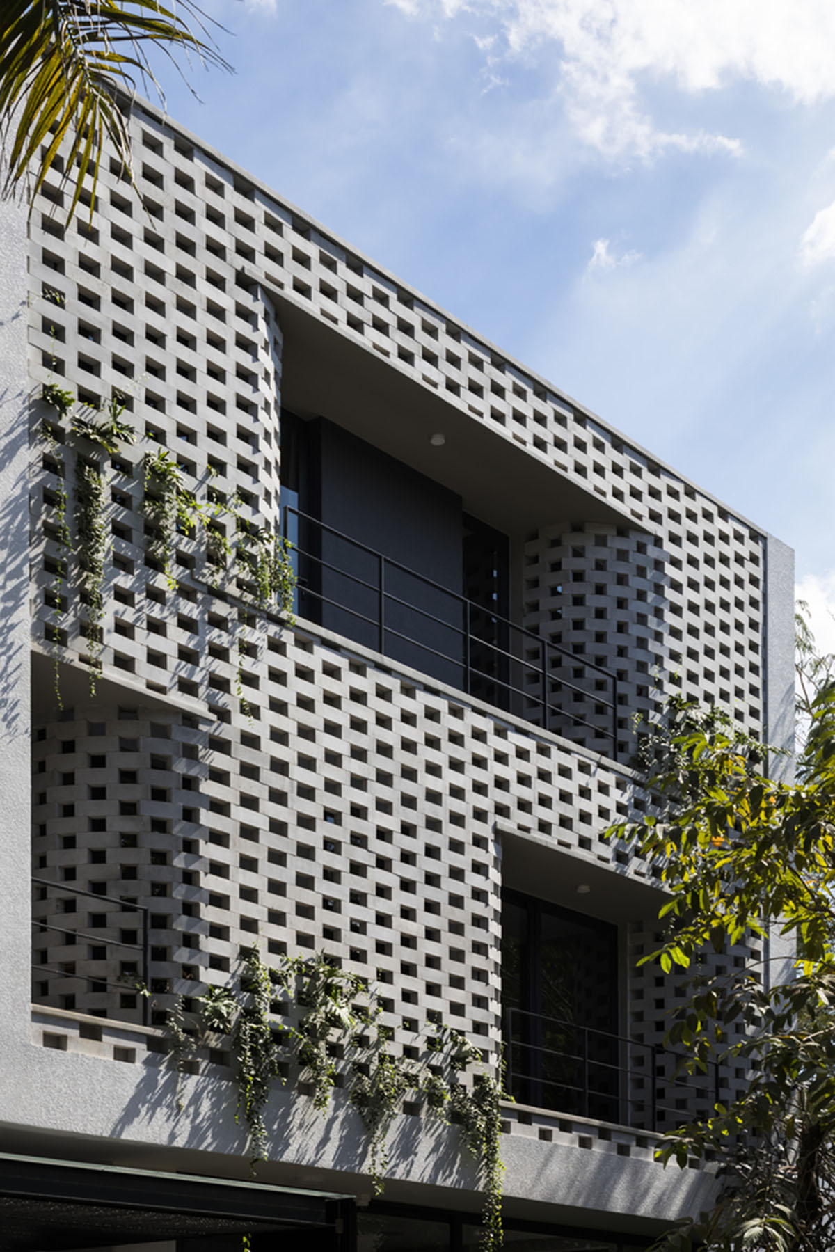Nha Dan Architects built this house with porous facade to provide maximum thermal comfort in Vietnam
