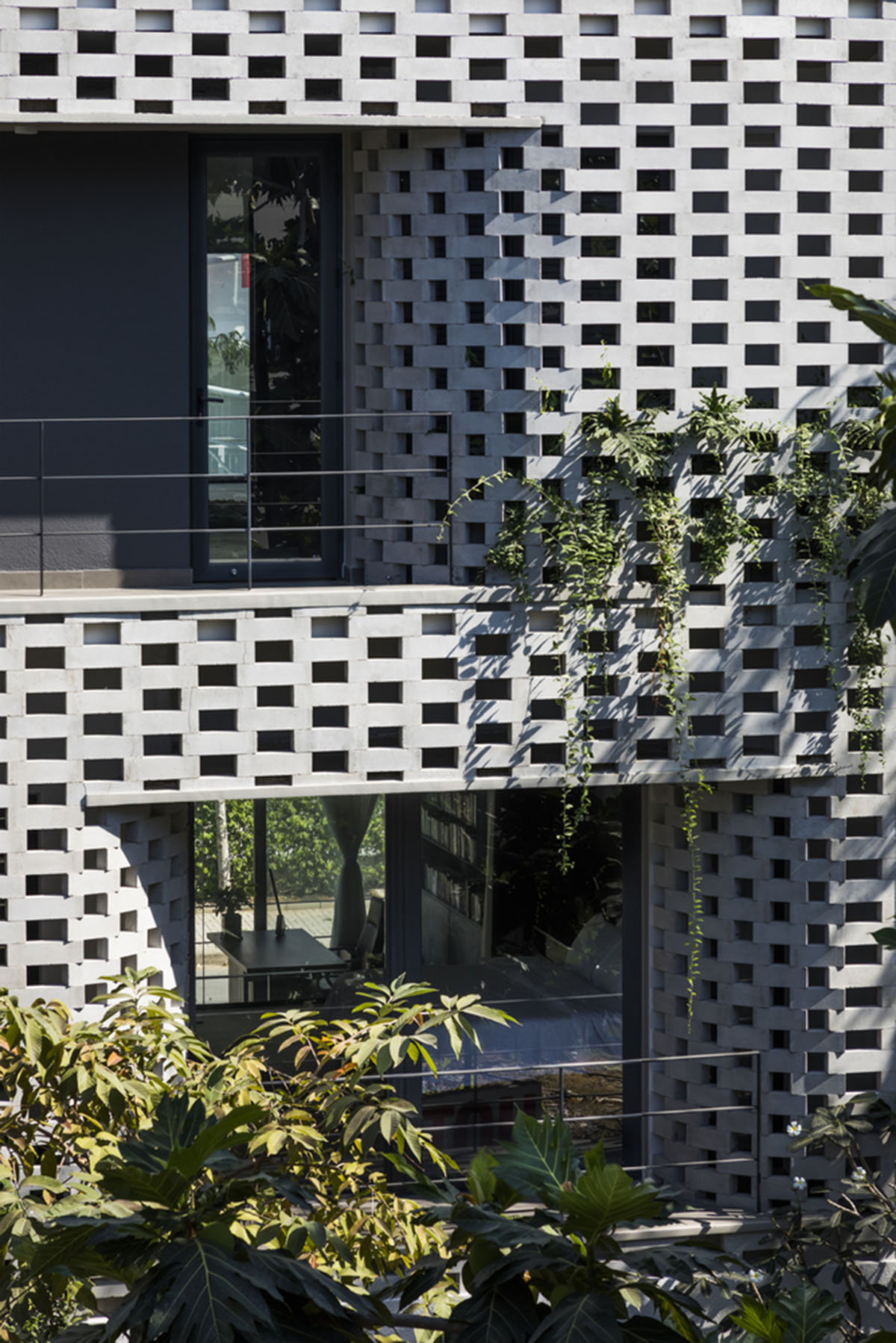 Nha Dan Architects built this house with porous facade to provide maximum thermal comfort in Vietnam
