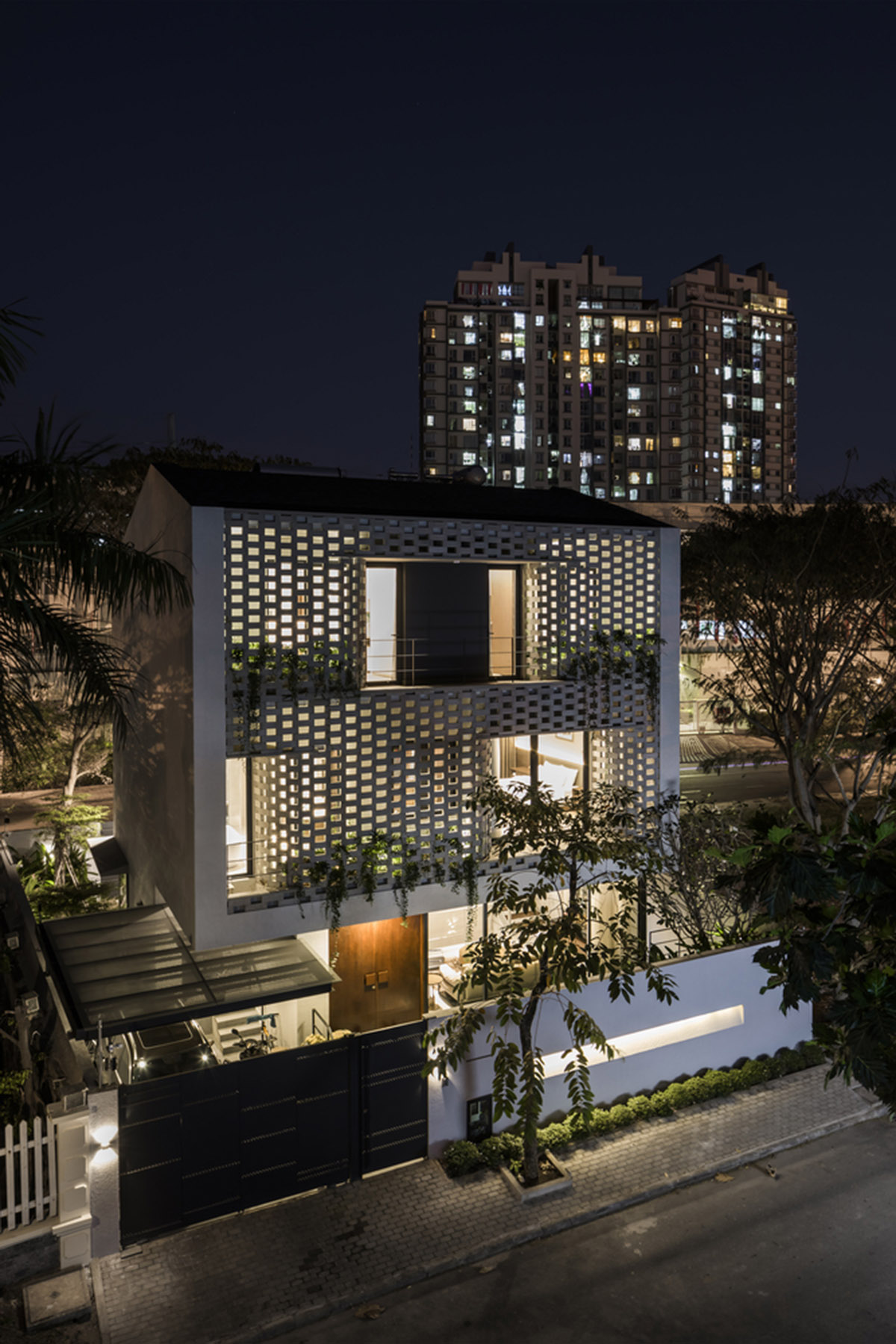 Nha Dan Architects built this house with porous facade to provide maximum thermal comfort in Vietnam