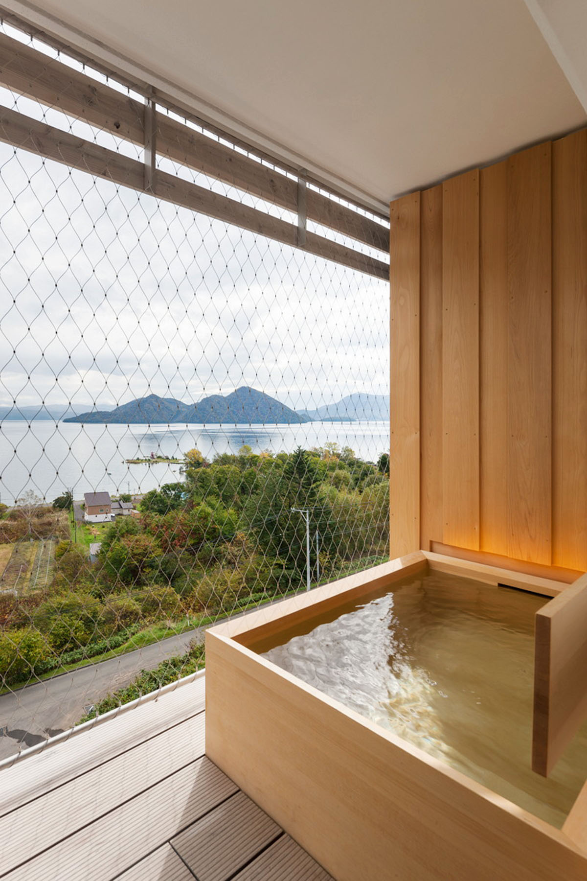 Kengo Kuma completes We Hotel Toya with cave-like interior on the shore of Lake Toya in Japan