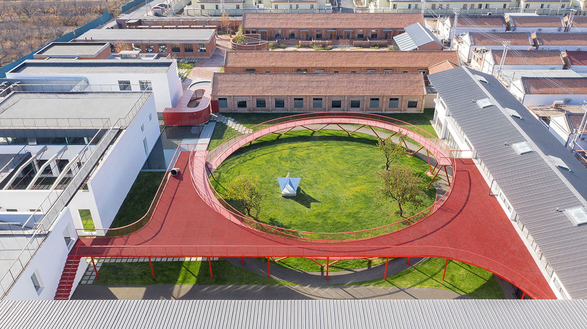 REDe Architects and Moguang Studio add red circular platform to renovated youth activity center