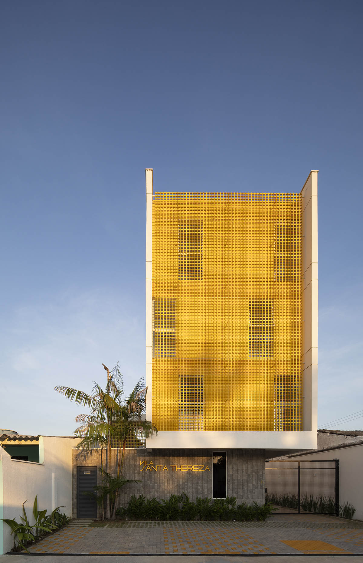 Manga - Vila Santa Thereza Building by Laurent Troost features yellow metal screen in Brazil