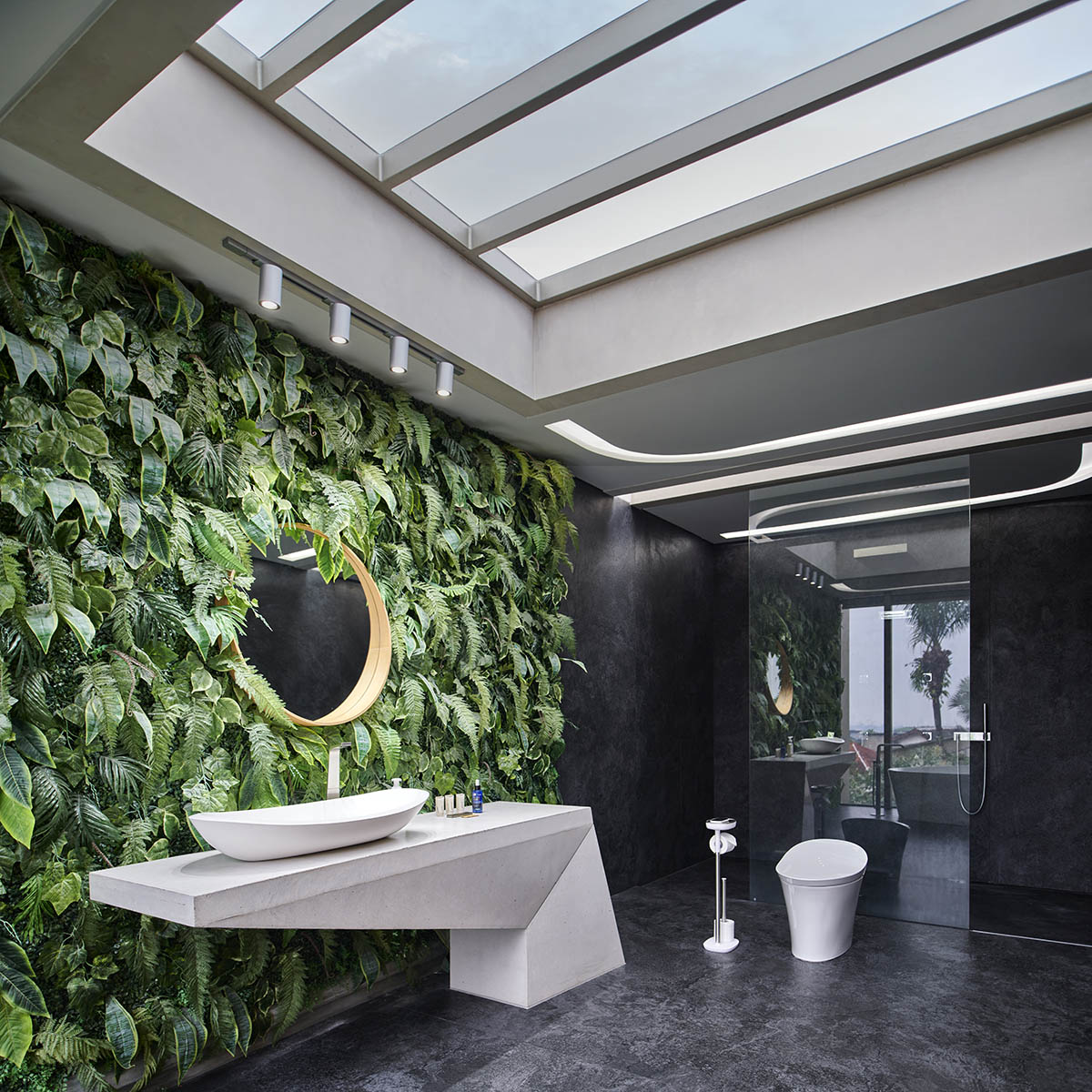 Undulating residence by RDMA is placed onto grass covered earth mound in Indonesia