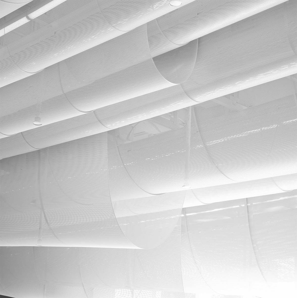 Atelier Nuno Architects suspends tubular aluminum panels from the ceiling of a lobby in Hong Kong