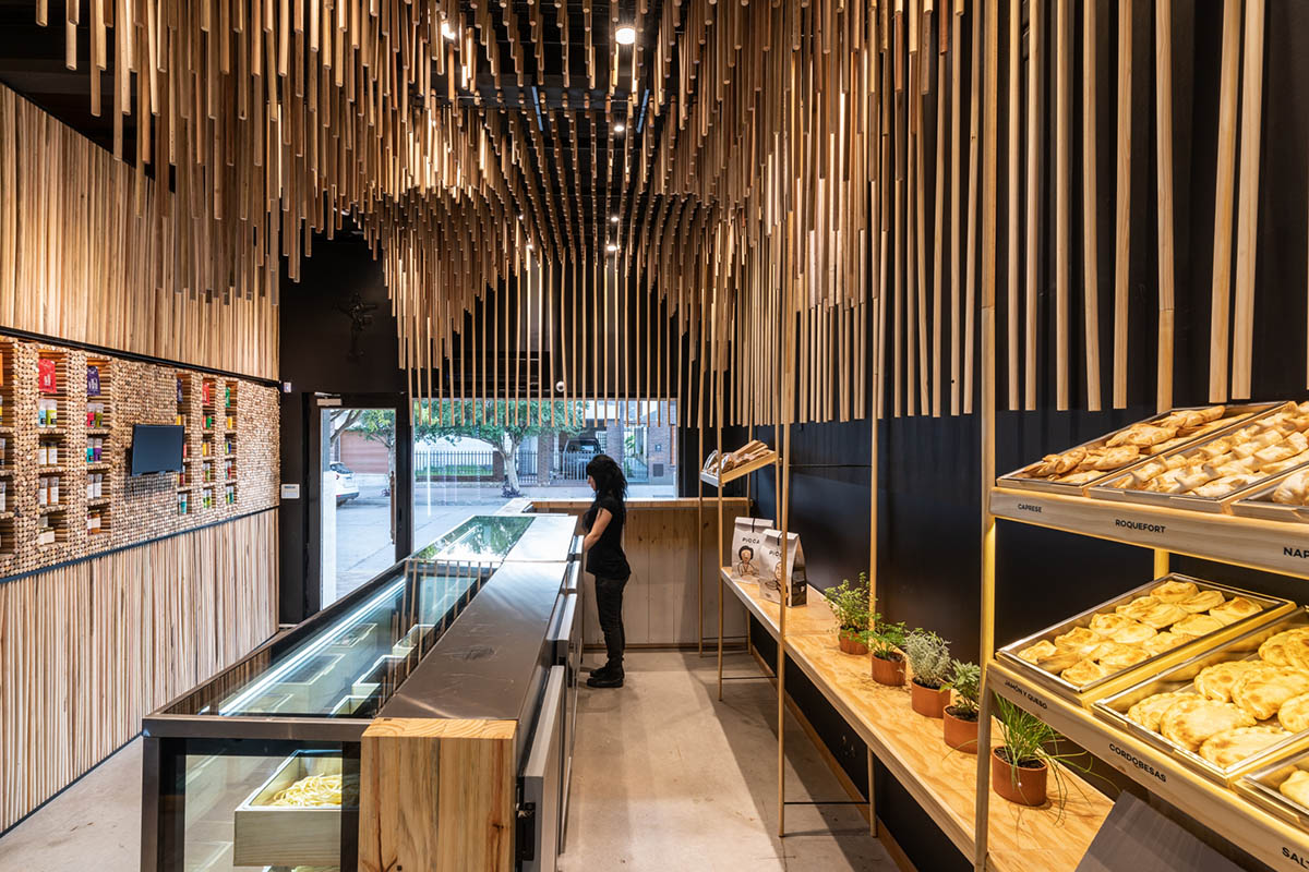 Efeeme arquitectos suspends thousands of broomsticks from the ceiling of patisserie in C&oacute;rdoba