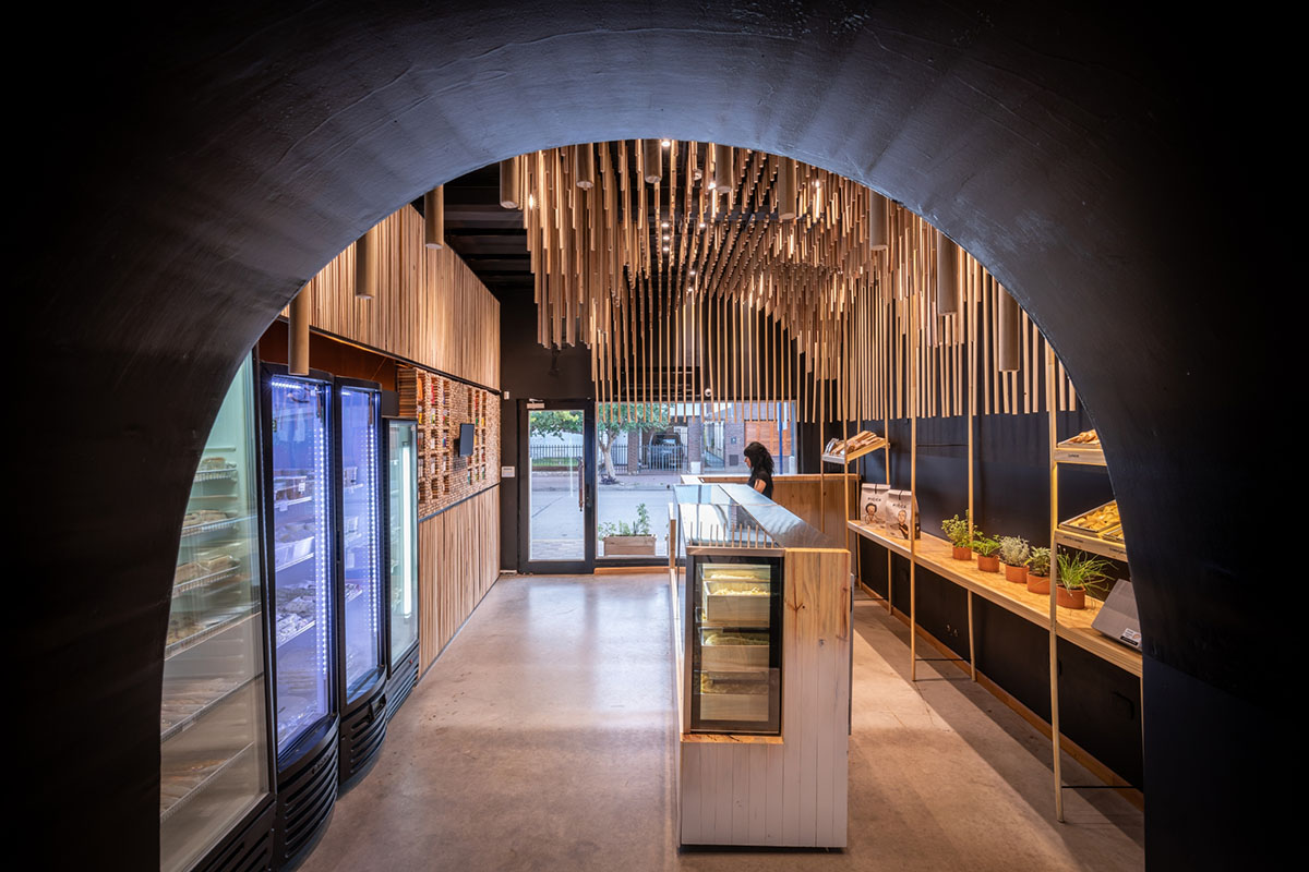 Efeeme arquitectos suspends thousands of broomsticks from the ceiling of patisserie in C&oacute;rdoba