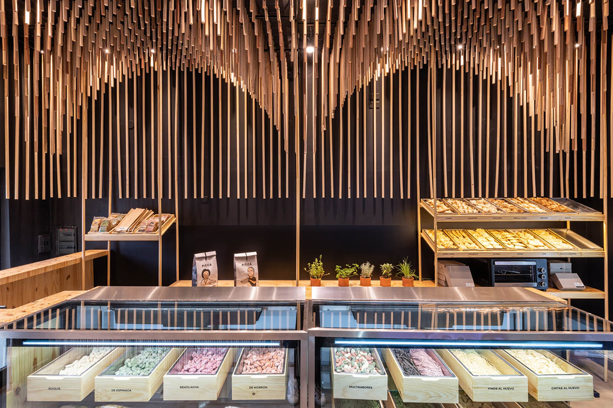 Efeeme arquitectos suspends thousands of broomsticks from the ceiling of patisserie in C&oacute;rdoba