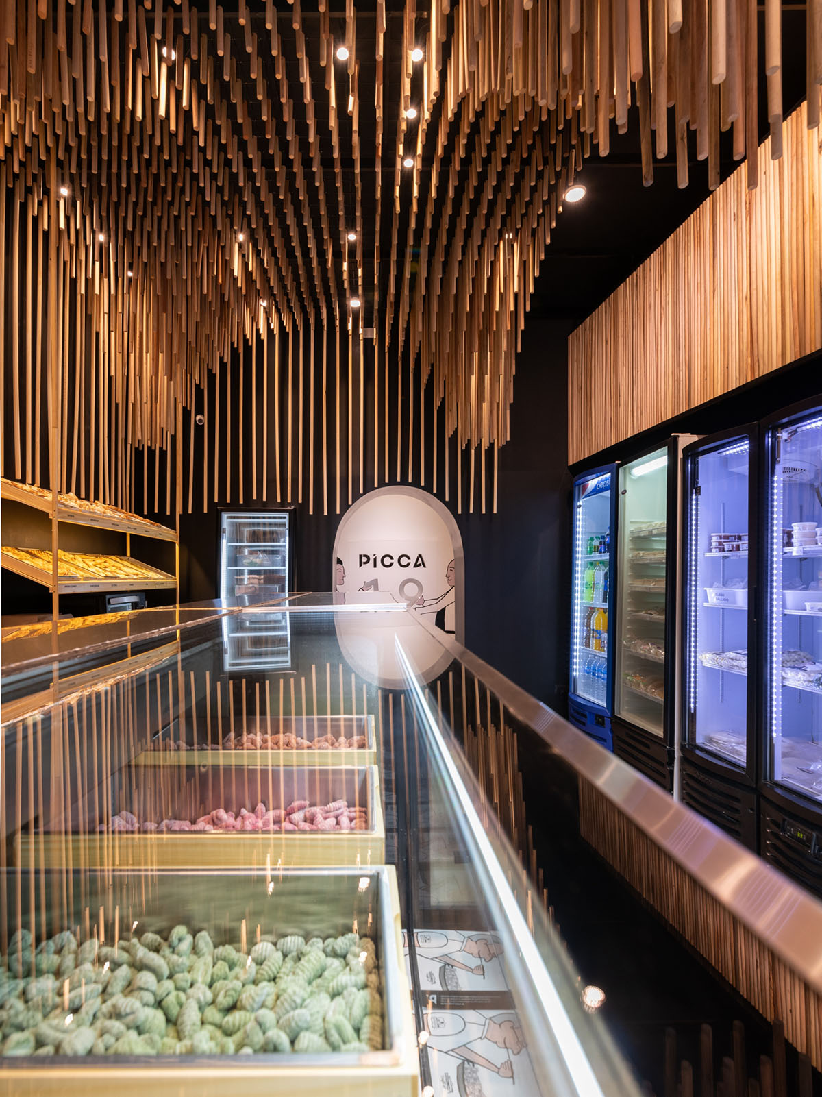 Efeeme arquitectos suspends thousands of broomsticks from the ceiling of patisserie in C&oacute;rdoba