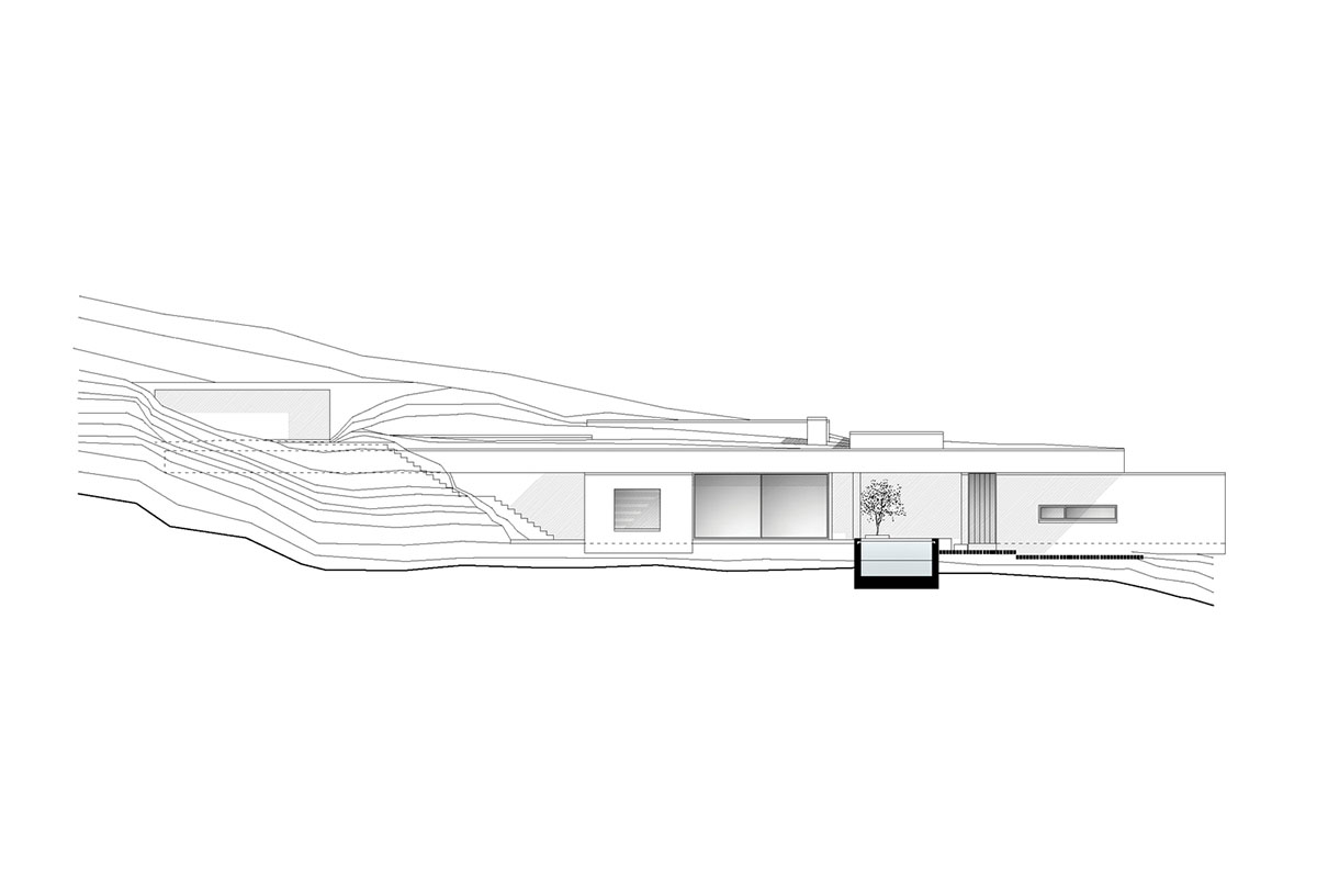 Swimming pool is bravely extended from inside of this concrete house towards endless view in Tinos