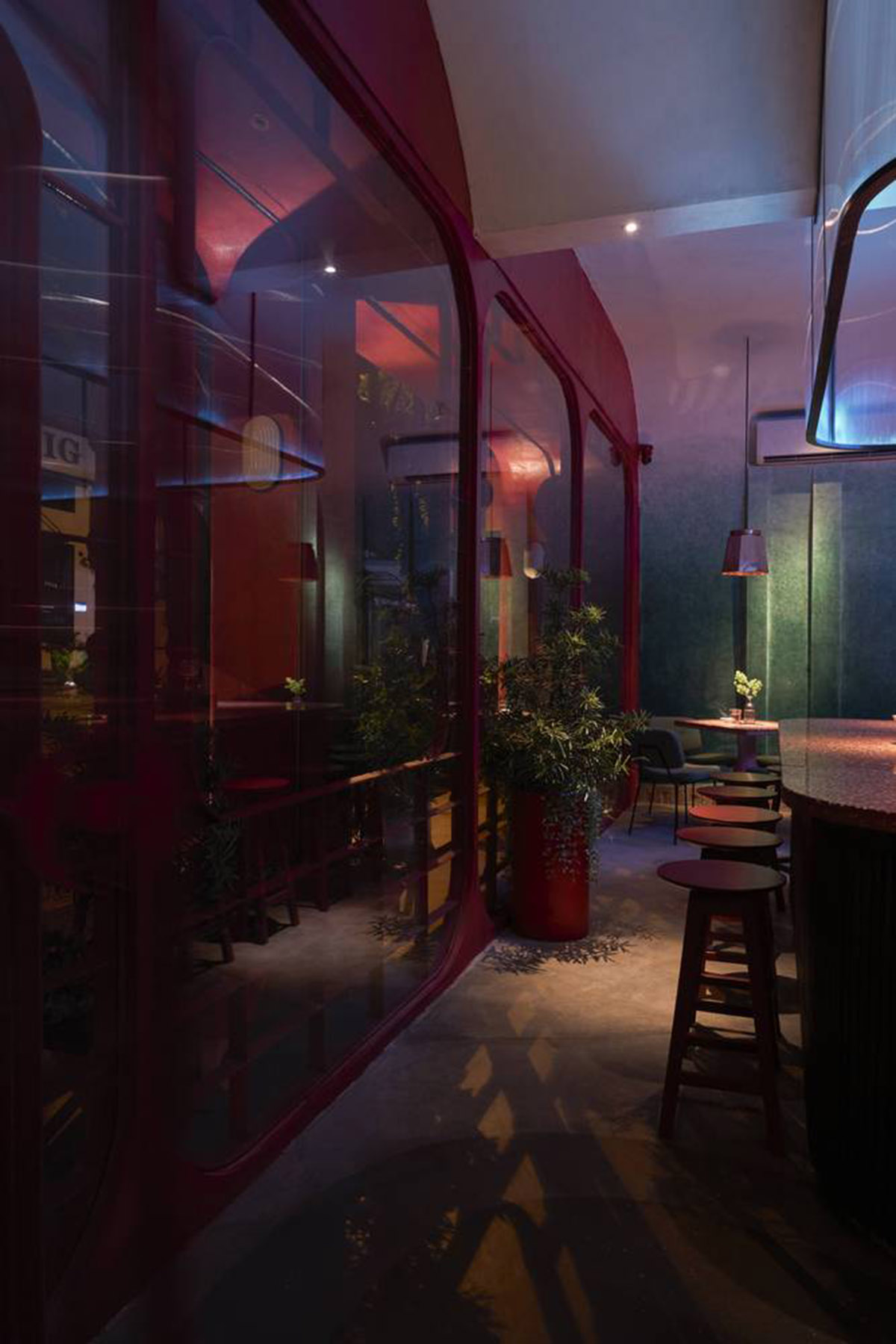 Red5studio built cafe evoking a retro spirit with hues of red colors and lights in Vietnam