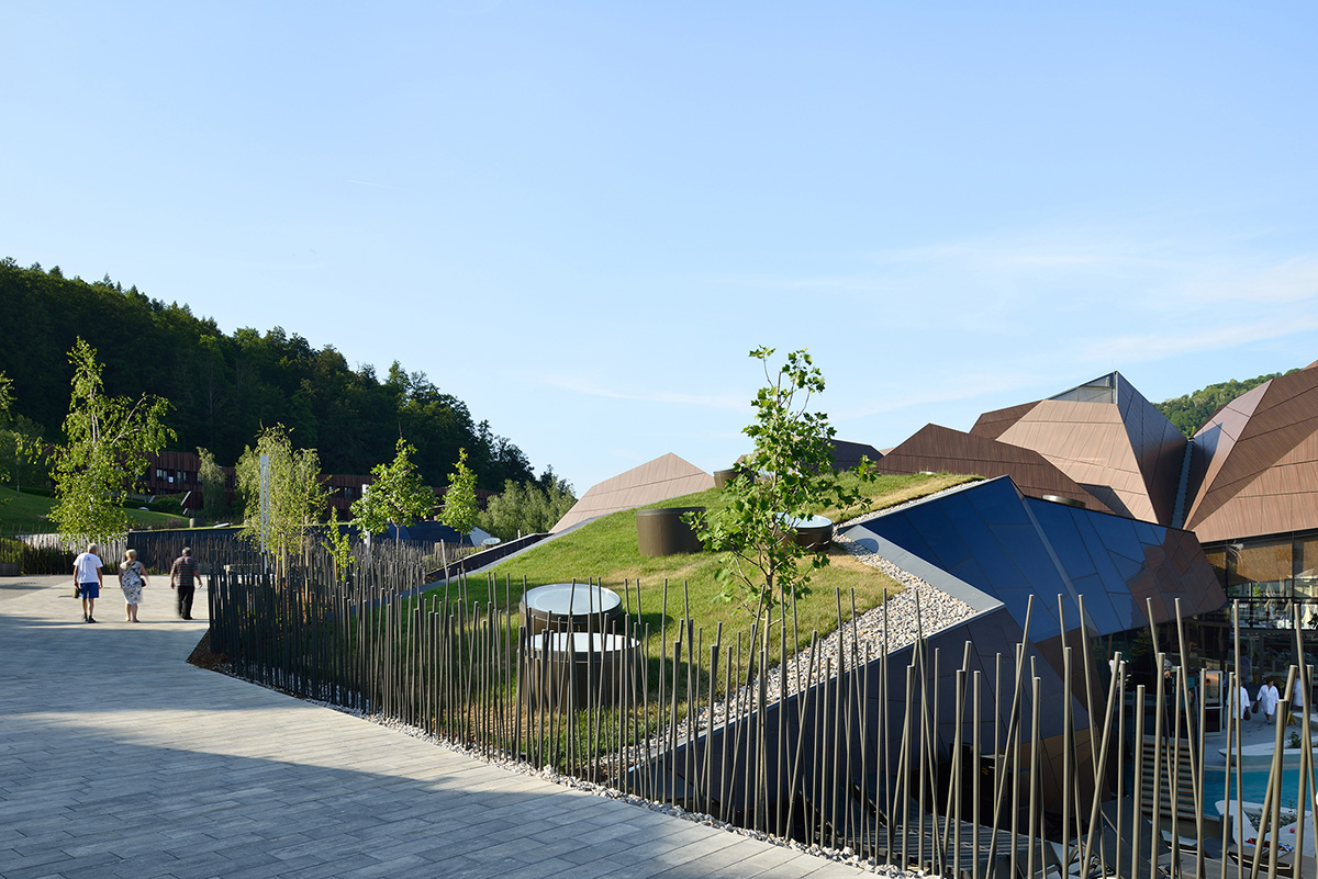 ENOTA's new spa complex made of tetrahedral volumes is spread as part of existing rural buildings