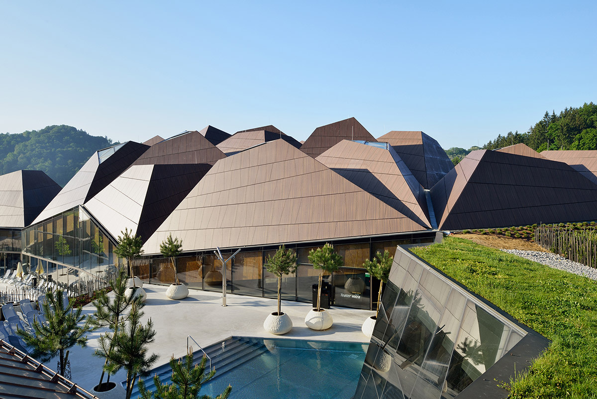 ENOTA's new spa complex made of tetrahedral volumes is spread as part of existing rural buildings