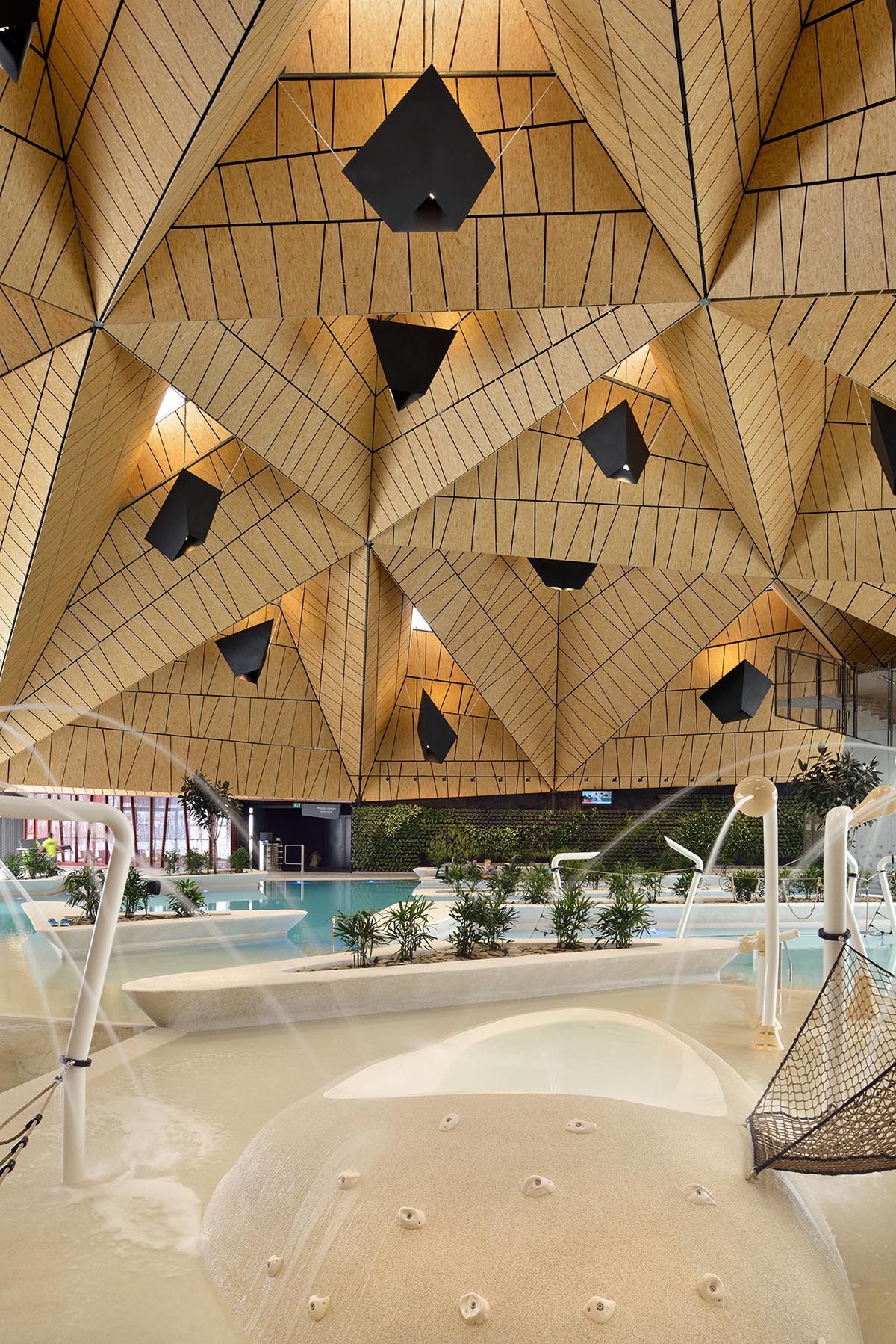 ENOTA's new spa complex made of tetrahedral volumes is spread as part of existing rural buildings