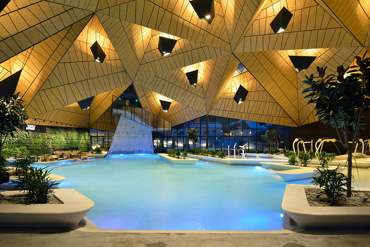 ENOTA's new spa complex made of tetrahedral volumes is spread as part of existing rural buildings