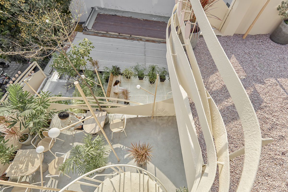 September Cafe is designed to look like a bird's nest with curved steel stripes in Vietnam