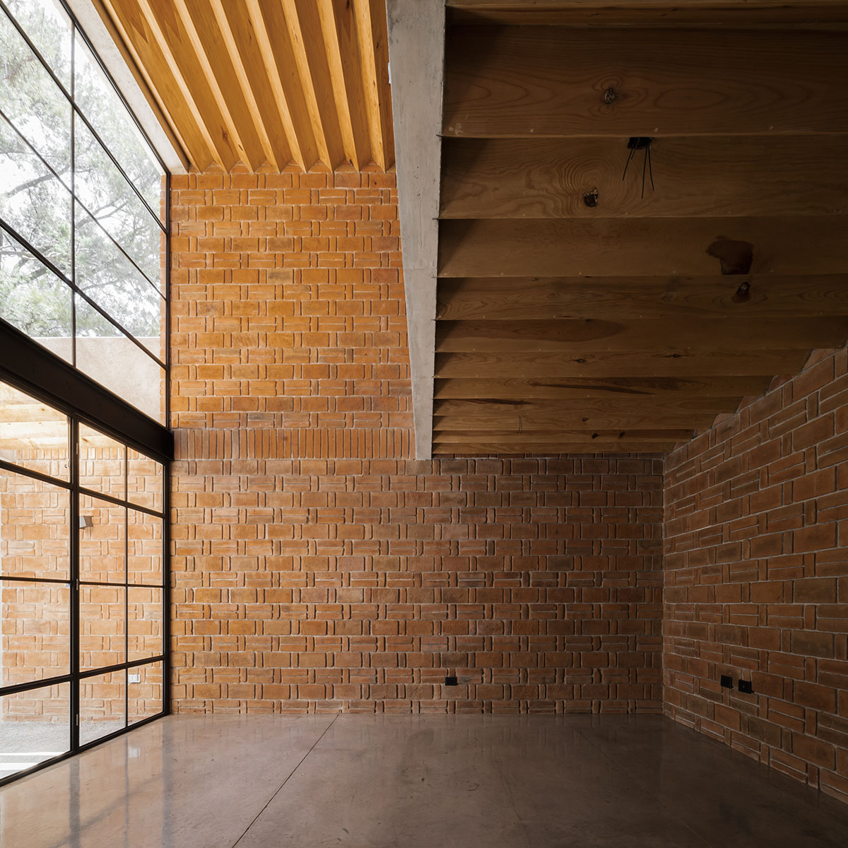 Estudio Tecalli uses red clay brick, concrete and glass to form MoMa House in Mexico