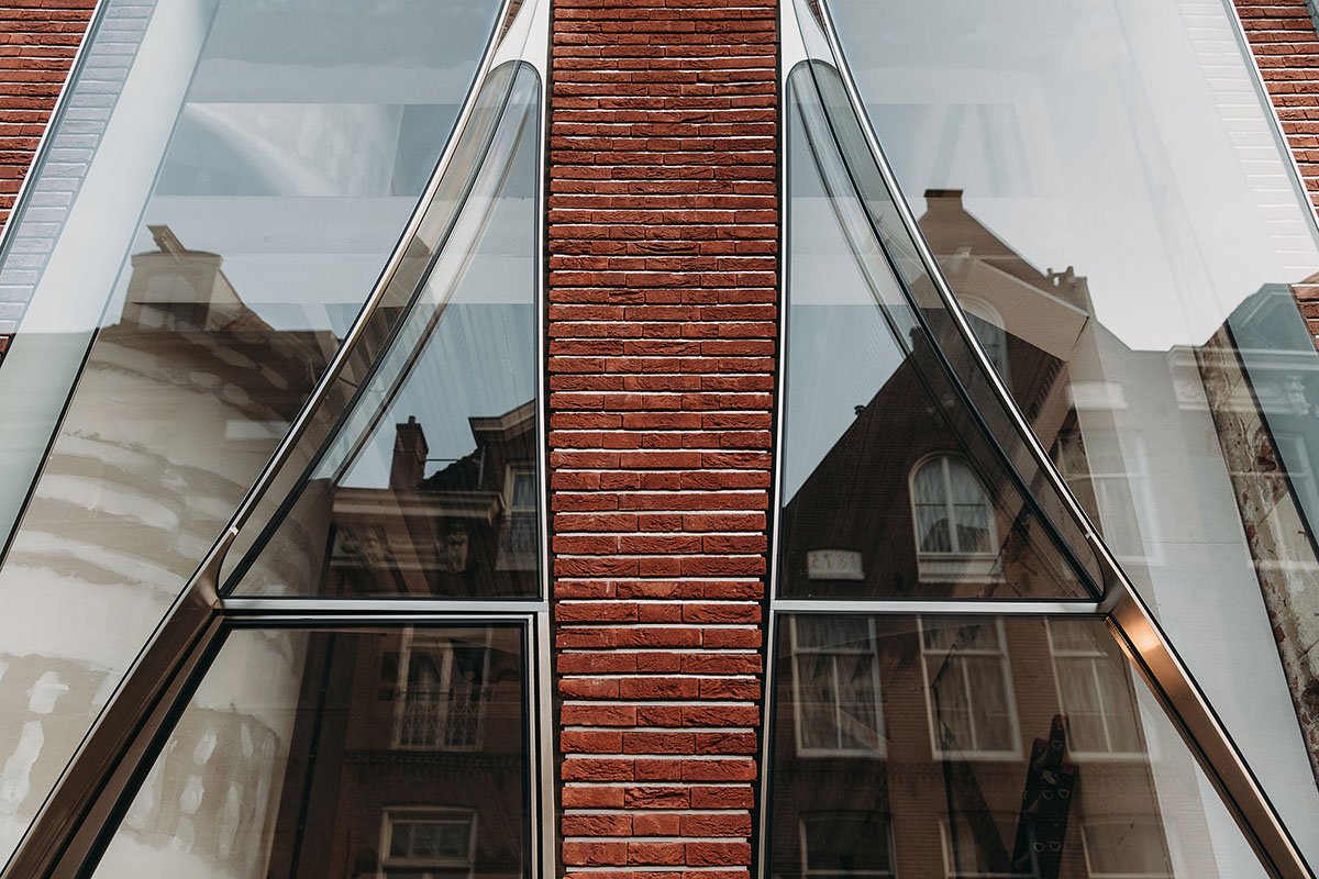 UNStudio combines curved glass panels with brickwork for Dutch flagship store in Amsterdam
