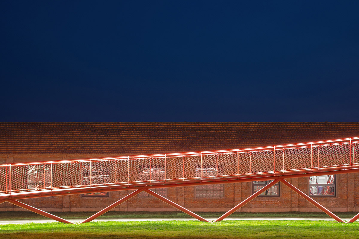 REDe Architects and Moguang Studio add red circular platform to renovated youth activity center