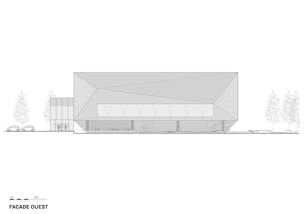 The gold-colored, folded facade gives a striking and symbolic presence to a new sports complex 