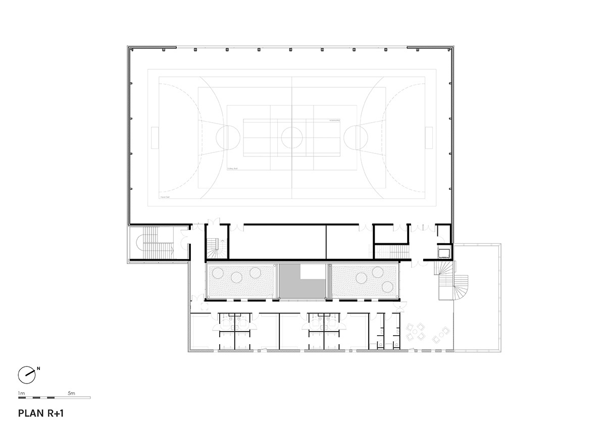 The gold-colored, folded facade gives a striking and symbolic presence to a new sports complex 