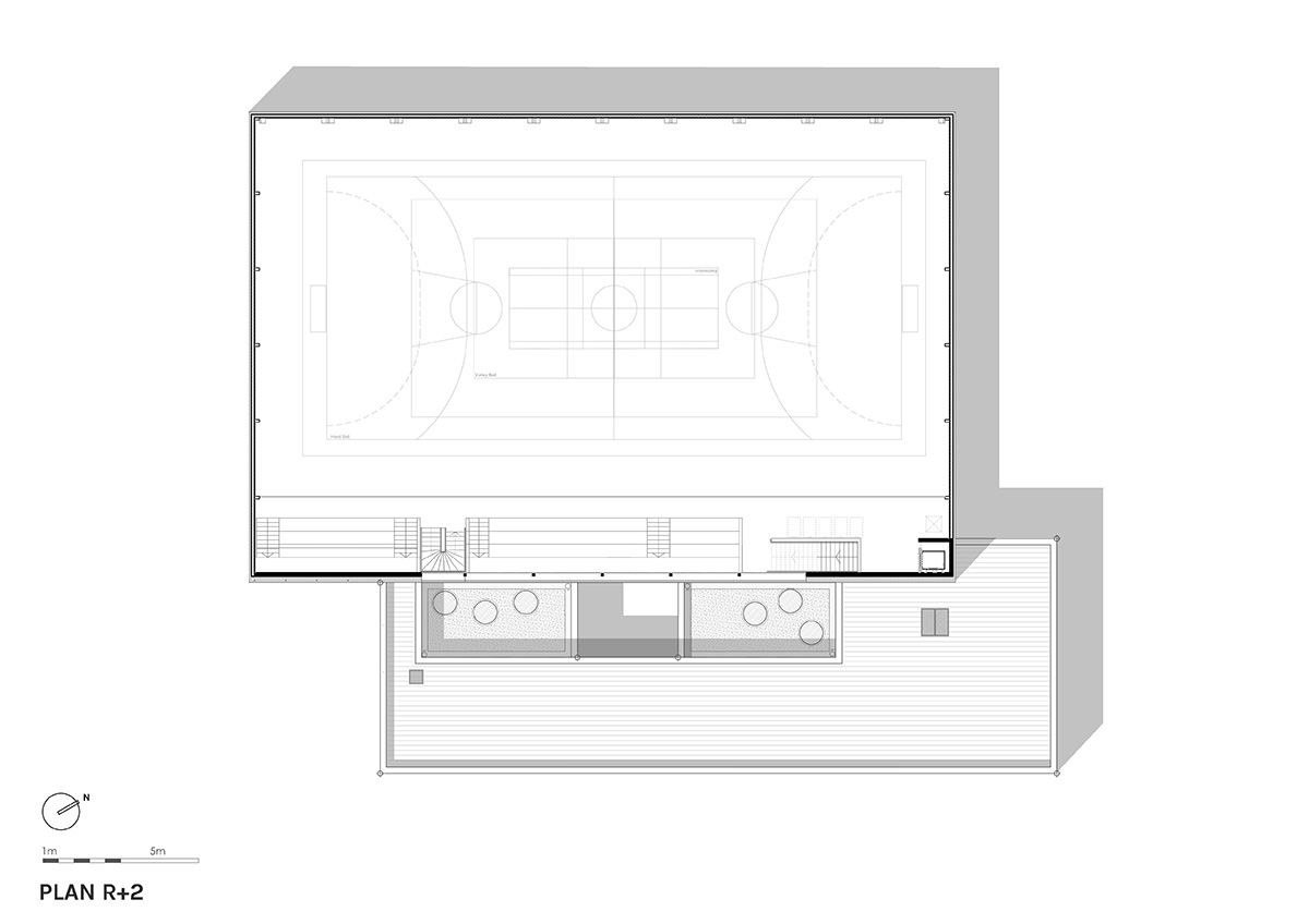 The gold-colored, folded facade gives a striking and symbolic presence to a new sports complex 
