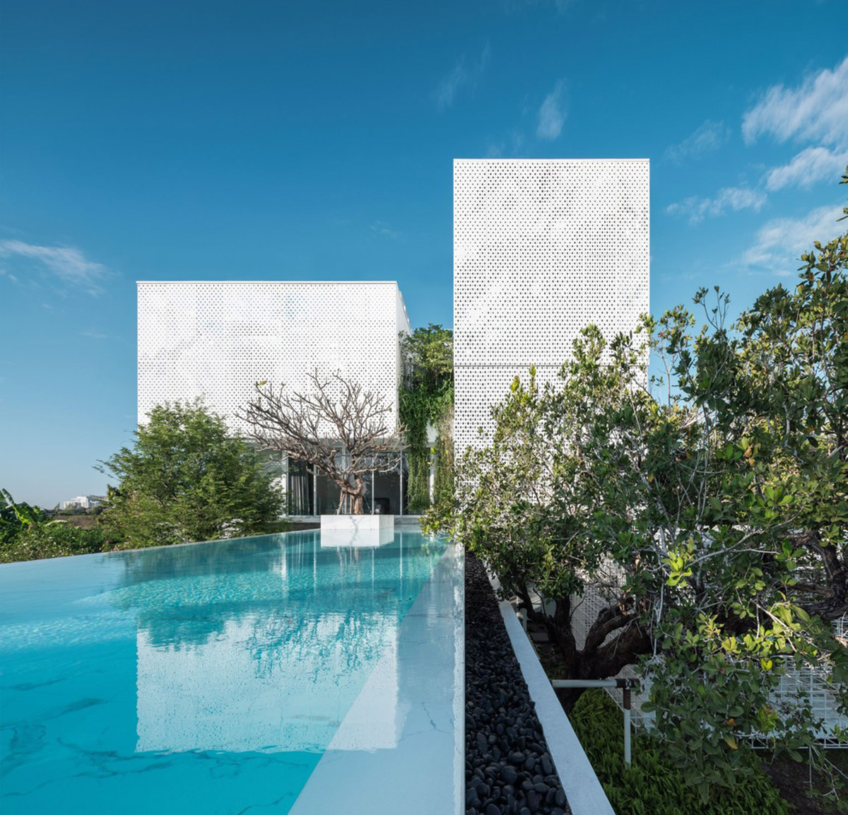 AAd built self-sustainable residence with perforated facade and steel rods in Thailand