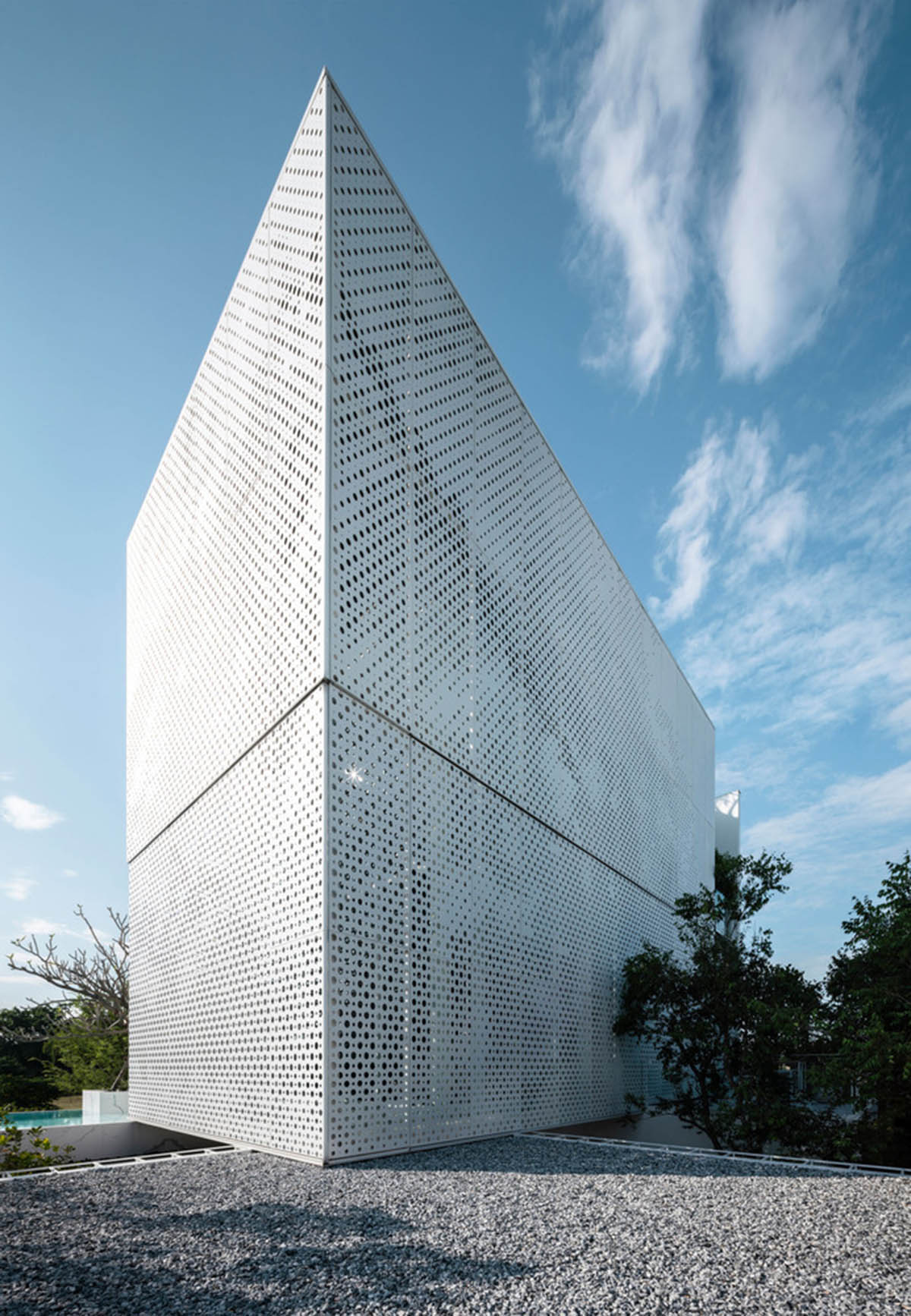 AAd built self-sustainable residence with perforated facade and steel rods in Thailand