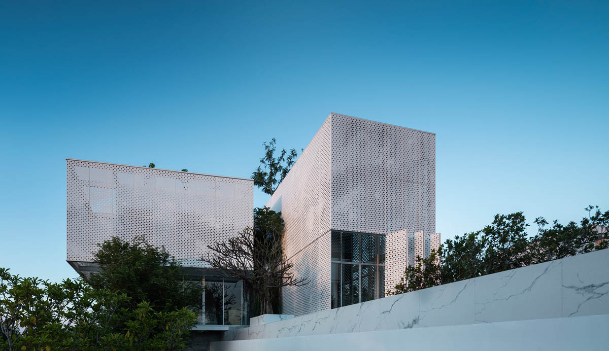 AAd built self-sustainable residence with perforated facade and steel rods in Thailand