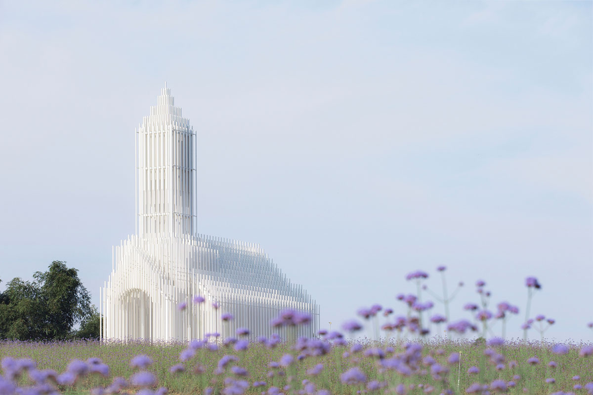 A church made of thousands of white thin beams looks like suspended in the air in lavender field