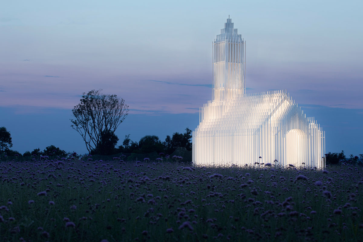 A church made of thousands of white thin beams looks like suspended in the air in lavender field