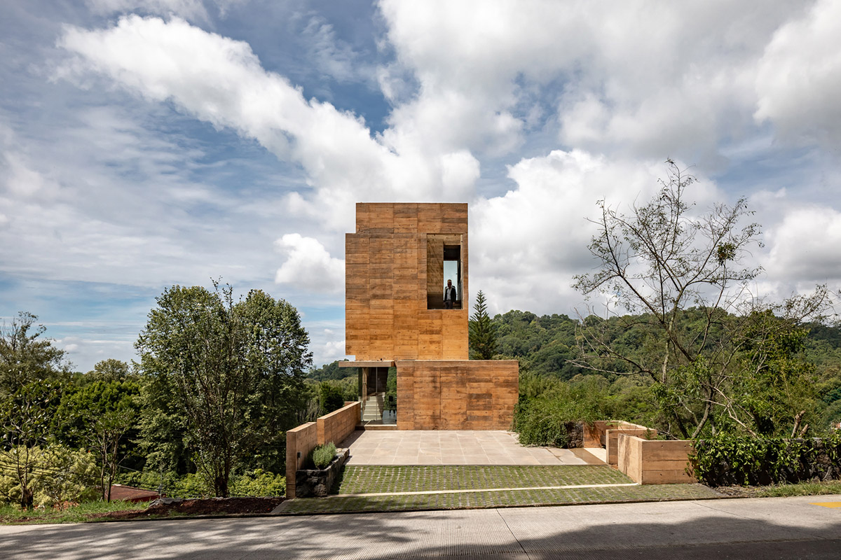 Earth-toned apartment building prioritizes views towards a forest in Coatepec, Mexico