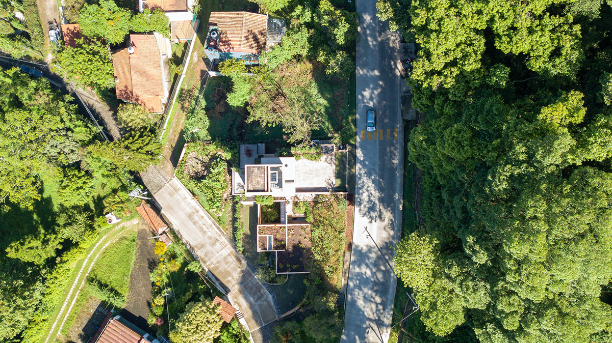 Earth-toned apartment building prioritizes views towards a forest in Coatepec, Mexico